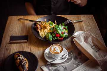 Breakfast table, man eating breakfast and drink coffee, close up