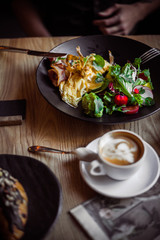 Breakfast table, man eating breakfast and drink coffee, close up