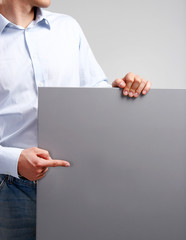 Businessman holding blank isolated on white background
