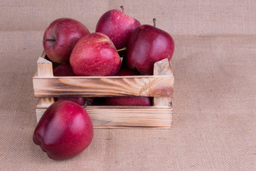 Red apples in a wooden crate