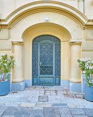 Fototapeta na wymiar Athens Greece, elegant house arch entrance with flowerpots