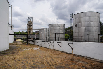 An industrial lot with big structures in the background.