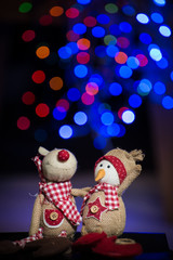 Christmas figurine toys on colorful bokeh background