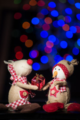 Christmas figurine toys on colorful bokeh background