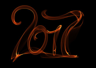 Happy new year 2017 isolated numbers lettering written with fire flame or smoke on black background