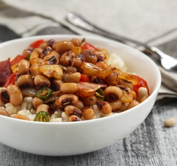 Homemade Hoppin john or carolina Peas served in a white bowl, selective focus