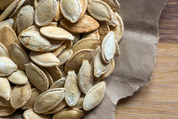 Grilled Pumpkin seeds with sea salt and spices on the wooden background