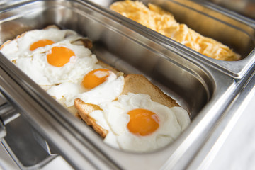 Catering buffet table with eggs and toast.