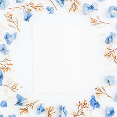 Frame of flowers and paper cards isolated on background. Flat lay. Top view.