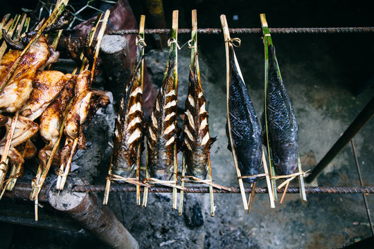 Fish roasts on a roadside in Laos