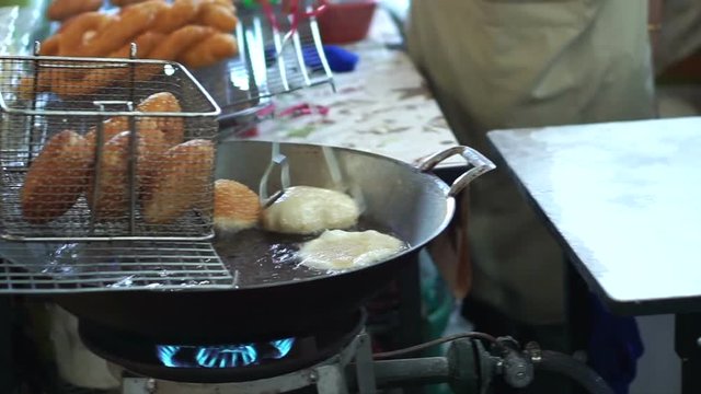 Traditional Chinese food, Hands frying Doughnut, drawing oil from deep-fried dough buns