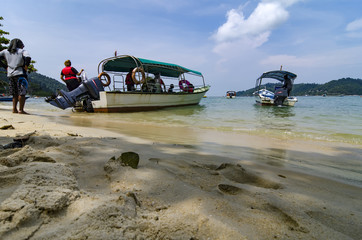 Tourist boat anchored over cloudy and blue sky background