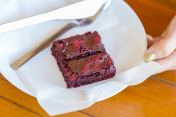 Homemade chocolate brownies decorated with fresh raspberry and bluberry