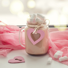 Cocoa with marshmallow on the windowsill. concept of Valentine's