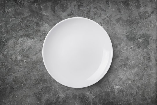 Empty plate on cement background. Top view with clipping path