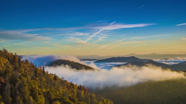 Autumn Sunrise over the Blue Ridge Mountains with Fast Moving Mist and Clouds seen from the Blue Ridge Parkway near Asheville in Western North Carolina