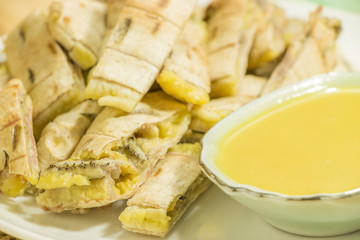 Banana slice and sweet sauce on plate