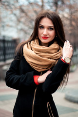 Autumn fashionable portrait of young happy brunette girl red lipstick outdoors in the city