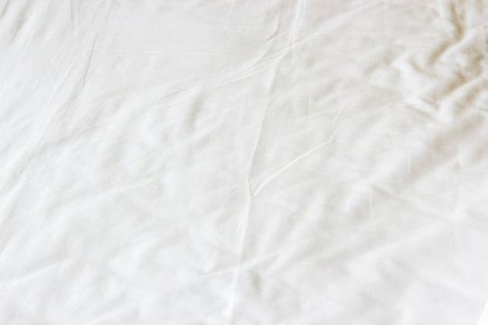 white crumpled bed sheet texture background