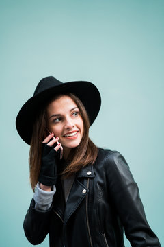 Young woman wearing hat talking phone