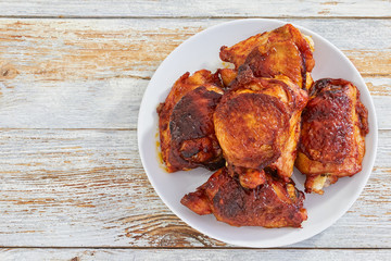 delicious fried chicken thigh on white plate, view from above