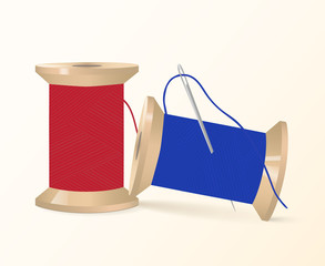 Two spools of thread with a needle
