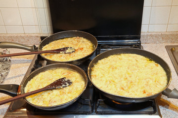 three large pots with the typical dish called FRICO Of the Itali