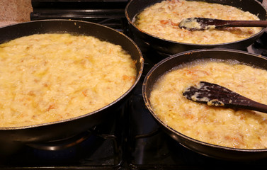 three large pots with FRICO with aged cheese and baked potatoes