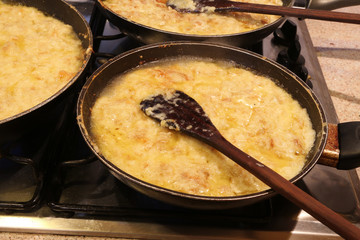 three large pots with the typical italian dish called FRICO