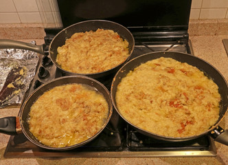 pots with the typical dish called FRICO Of the Italian region