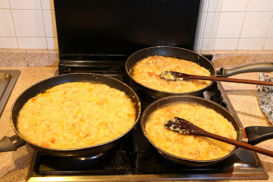 three large pots with the typical dish called FRICO of Italy