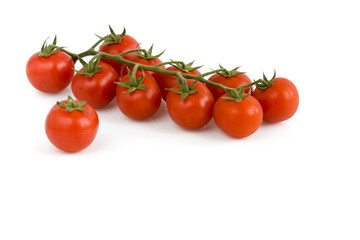 Bunch of cherry tomatoes on white background. Still-life picture taken in studio with soft-box.