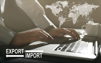 Logistics concept. Man with laptop, closeup. Text EXPORT-IMPORT on background