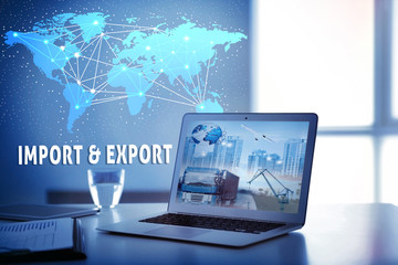 Laptop on table at office. World map and text IMPORT and EXPORT on background. Wholesale and...