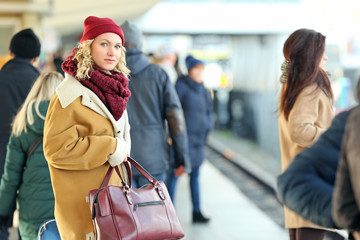 Woman at the railway station with bag