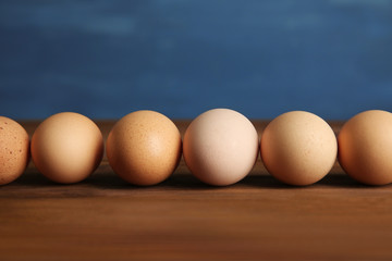 Raw eggs on wooden table