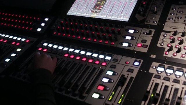 The work of the sound engineer behind the mixing Desk at the concert.