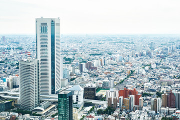 Naklejka premium Asia Business concept for real estate and corporate construction - panoramic modern cityscape building bird eye aerial view under sunrise and morning blue bright sky in Tokyo, Japan