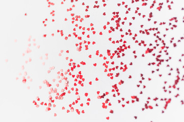 a scattering of red hearts on a white background. Texture for Valentine's day