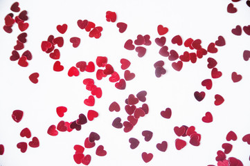 a scattering of red hearts on a white background. Texture for Valentine's day