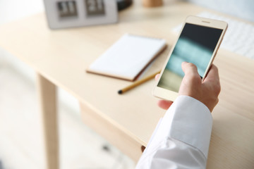 Man using smart phone in office