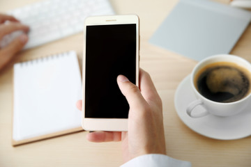 Man using smart phone in office