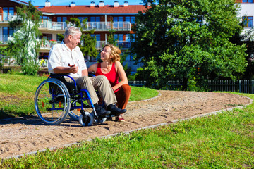 man on wheelchair with young woman