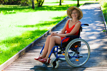 Fototapeta na wymiar happy young adult woman on wheelchair