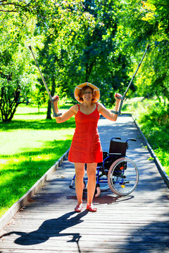 handicapped woman raising her crutches