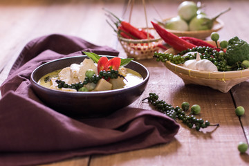 Chicken mussaman curry in bowl vegetables on wooden background