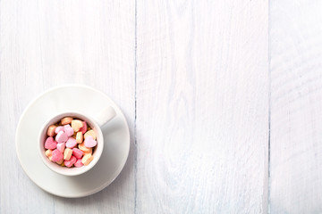 cup full of heart shaped candies