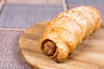 Puff pastry stuffed with sausages on the plate