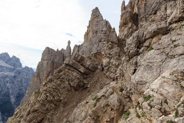 People climbing the Via Ferrata Severino Casara in Sexten Dolomites mountains, South Tyrol, Italy
