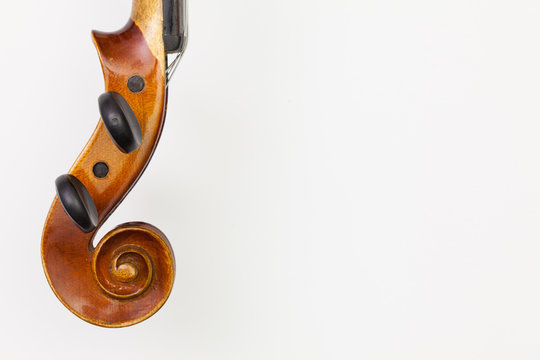 Top view close up shot of old violin on the white table.